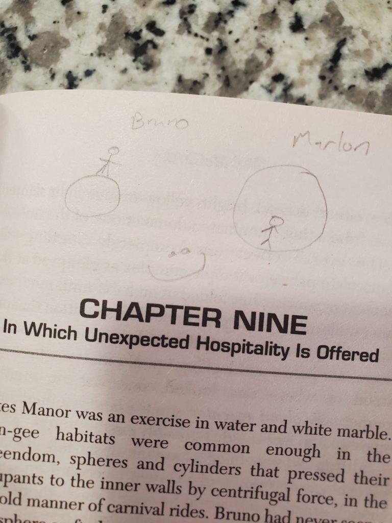 At the top of the first page of chapter nine, a pencil sketch shows Bruno on the outside of a tiny planet and Marlon on the inside of a hollow one, with a smiley face below.